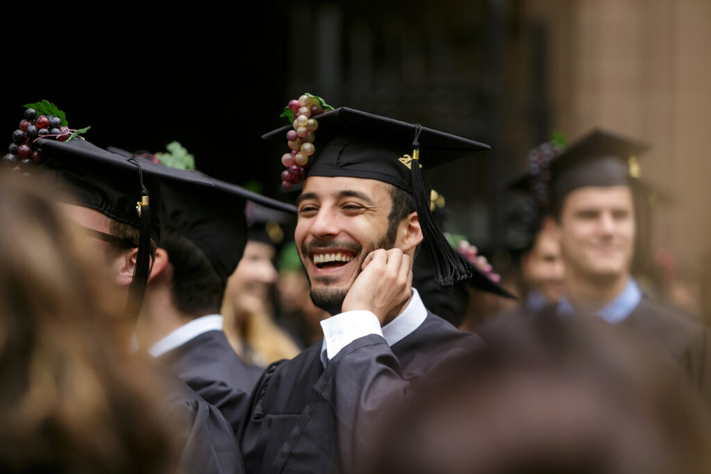 A joyful new grad during his graduation ceremony.