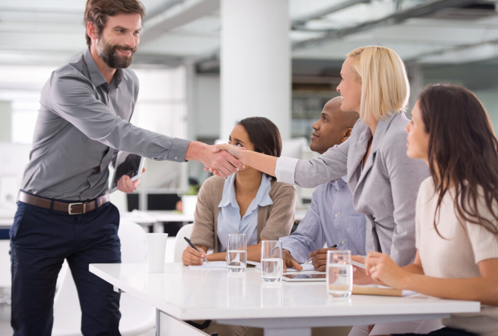 In-person business introduction with a handshake, highlighting strong physical presence.